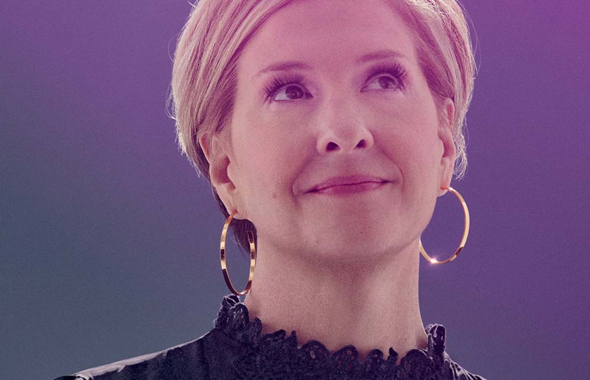 Brene Brown smiles on stage will delivering the wisdom.