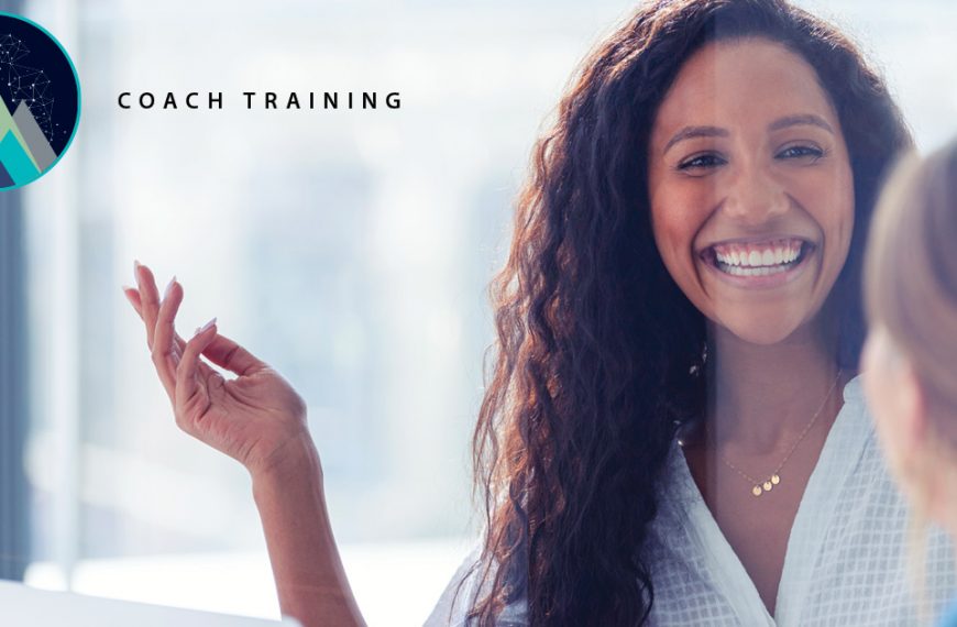 A coach training icon floats in the top left hand corner, and the coach laughs while working with a client.