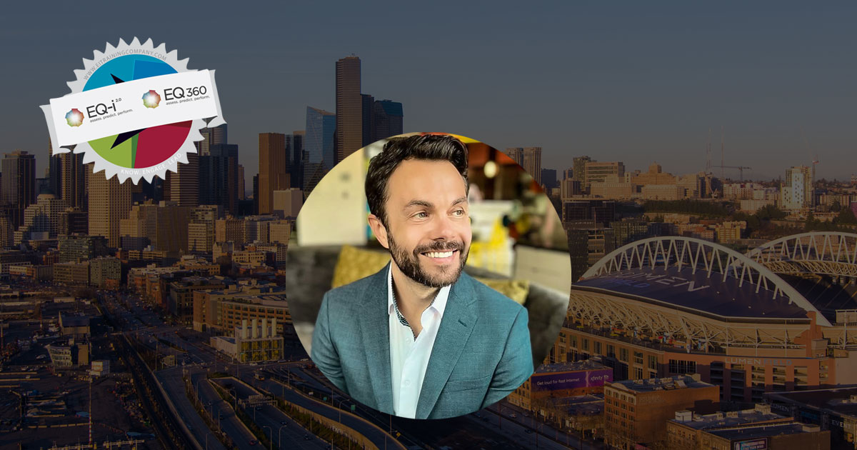 David VanGeystel smiles warmly with Seattle in the background as well as the EQ-i 2.0 icons.